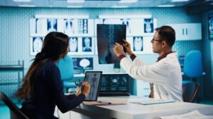 Doctor discussing medical images with patient.